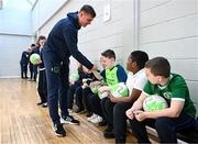 24 November 2022; Republic of Ireland international Evan Ferguson with pupils from Scoil Chiaráin  during the launch of Football for All - Futsal in the Yard programme at the Scoil Chiaráin in Glasnevin, Dublin. Photo by Eóin Noonan/Sportsfile