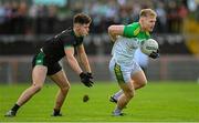 27 November 2022; Alex Doherty of Glen Watty Graham's in action against Cahir Donnelly of Erin's Own Cargin during the AIB Ulster GAA Football Senior Club Championship Semi Final match between Erin's Own Cargin and Glen Watty Graham's at O'Neill's Healy Park in Omagh. Photo by Ramsey Cardy/Sportsfile