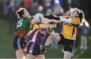 27 November 2022; Denise Gaule of Mullinahone in action against Megan Maguire, right, and Andrea Gordon of Derrygonnelly Harps during the CurrentAccount.ie LGFA All-Ireland Intermediate Club Championship Semi-Final match between Mullinahone, Tipperary, and Derrygonnelly, Fermanagh, at John Locke Park in Callan, Kilkenny. Photo by David Fitzgerald/Sportsfile