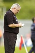 23 May 2004; Armagh manager Joe Kernan makes notes during the final minutes of the game. Bank of Ireland Ulster Senior Football Championship, Monaghan v Armagh, St. Tighernach's Park, Clones, Co. Monaghan. Picture credit; Pat Murphy / SPORTSFILE