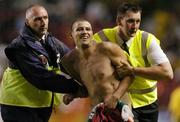 2 June 2004; A streaker is escorted from the field. Unity Cup, Republic of Ireland v Jamaica, The Valley, London, England. Picture credit; Pat Murphy / SPORTSFILE
