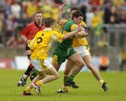30 May 2004; Michael Hegarty, Donegal, in action against Sean Kelly (6) and Gearoid Adams, Antrim. Bank of Ireland Ulster Senior Football Championship, Donegal v Antrim, McCool Park, Ballybofey, Co. Donegal. Picture credit; Damien Eagers / SPORTSFILE