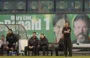 4 June 2004; Stephen Kenny, Bohemians manager, and the Bohemians bench watch the match with a Sinn Fein bus in the backround. eircom league, Premier Division, Bohemians v Derry City, Dalymount Park, Dublin. Picture credit; Damien Eagers / SPORTSFILE