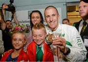 16 August 2013; Men's 50k walk gold medal winner Robert Heffernan with his wife Marian and children Cathal, age 8, and Meghan, age 10, in Dublin airport on his return from the IAAF World Athletics Championships in Moscow. Dublin Airport, Dublin. Picture credit: Brian Lawless / SPORTSFILE
