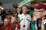 16 August 2013; Men's 50k walk gold medal winner Robert Heffernan with his wife Marian and children Cathal, age 8, and Meghan, age 10, and his father Bobby Heffernan, right, in Dublin airport on his return from the IAAF World Athletics Championships in Moscow. Dublin Airport, Dublin. Picture credit: Brian Lawless / SPORTSFILE