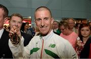 16 August 2013; Ireland's Robert Heffernan, and Professor Ciarán Ó Catháin, President, Athletics Ireland, with his men's 50k walk gold medal in Dublin airport on his return from the IAAF World Athletics Championships in Moscow. Dublin Airport, Dublin. Picture credit: Brian Lawless / SPORTSFILE