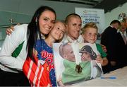 16 August 2013; Men's 50k walk gold medal winner Robert Heffernan with his wife Marian and children Cathal, age 8, and Meghan, age 10, in Dublin airport on his return from the IAAF World Athletics Championships in Moscow. Dublin Airport, Dublin. Photo by Sportsfile