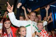 16 August 2013; Men's 50k walk gold medal winner Robert Heffernan with children Cathal, age 8, and Meghan, age 10, in Dublin airport on his return from the IAAF World Athletics Championships in Moscow. Dublin Airport, Dublin. Picture credit: Brian Lawless / SPORTSFILE