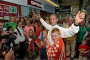 16 August 2013; Men's 50k walk gold medal winner Robert Heffernan with children Cathal, age 8, and Meghan, age 10, in Dublin airport on his return from the IAAF World Athletics Championships in Moscow. Dublin Airport, Dublin. Picture credit: Brian Lawless / SPORTSFILE