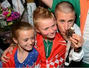 16 August 2013; Men's 50k walk gold medal winner Robert Heffernan with children Cathal, age 8, and Meghan, age 10, in Dublin airport on his return from the IAAF World Athletics Championships in Moscow. Dublin Airport, Dublin. Photo by Sportsfile