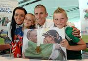 16 August 2013; Men's 50k walk gold medal winner Robert Heffernan with his wife Marian and children Cathal, age 8, and Meghan, age 10, in Dublin airport on his return from the IAAF World Athletics Championships in Moscow. Dublin Airport, Dublin. Picture credit: Brian Lawless / SPORTSFILE