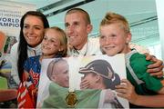 16 August 2013; Men's 50k walk gold medal winner Robert Heffernan with his wife Marian and children Cathal, age 8, and Meghan, age 10, in Dublin airport on his return from the IAAF World Athletics Championships in Moscow. Dublin Airport, Dublin. Picture credit: Brian Lawless / SPORTSFILE