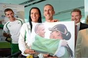 16 August 2013; Men's 50km gold medal winner Robert Heffernan and his wife Marian after being presented with a photograph, alongside athlete Brendan Boyce and Professor Ciarán Ó Catháin, President, Athletics Ireland, in Dublin airport on his return from the IAAF World Athletics Championships in Moscow. Dublin Airport, Dublin. Picture credit: Brian Lawless / SPORTSFILE