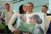 16 August 2013; Men's 50km gold medal winner Robert Heffernan and his wife Marian after being presented with a photograph, alongside athlete Brendan Boyce and Professor Ciarán Ó Catháin, President, Athletics Ireland, in Dublin airport on his return from the IAAF World Athletics Championships in Moscow. Dublin Airport, Dublin. Picture credit: Brian Lawless / SPORTSFILE