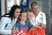 16 August 2013; Men's 50k walk gold medal winner Robert Heffernan with his wife Marian and children Cathal, age 8, and Meghan, age 10, in Dublin airport on his return from the IAAF World Athletics Championships in Moscow. Dublin Airport, Dublin. Picture credit: Brian Lawless / SPORTSFILE