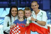 16 August 2013; Men's 50k walk gold medal winner Robert Heffernan with his wife Marian and children Cathal, age 8, and Meghan, age 10, in Dublin airport on his return from the IAAF World Athletics Championships in Moscow. Dublin Airport, Dublin. Photo by Sportsfile