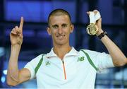 16 August 2013; Ireland's Robert Heffernan with his men's 50k walk gold medal in Dublin airport on his return from the IAAF World Athletics Championships in Moscow. Dublin Airport, Dublin. Photo by Sportsfile