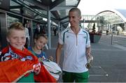 16 August 2013; Men's 50k walk gold medal winner Robert Heffernan with children Cathal, age 8, and Meghan, age 10, in Dublin airport on his return from the IAAF World Athletics Championships in Moscow. Dublin Airport, Dublin. Picture credit: Brian Lawless / SPORTSFILE