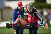 27 November 2022; Aoibhe O'Shea of Mullinahone is carried off with cramp during the CurrentAccount.ie LGFA All-Ireland Intermediate Club Championship Semi-Final match between Mullinahone, Tipperary, and Derrygonnelly, Fermanagh, at John Locke Park in Callan, Kilkenny. Photo by David Fitzgerald/Sportsfile