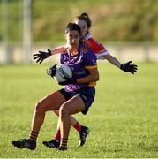 27 November 2022; Éabha Rutledge of Kilmacud Crokes in action against Sharon Courtney of Donaghmoyne during the CurrentAccount.ie LGFA All-Ireland Senior Club Championship Semi-Final match between Donaghmoyne, Monaghan, and Kilmacud Crokes, Dublin, at Cornaslieve in Carrickmacross, Monaghan. Photo by Philip Fitzpatrick/Sportsfile