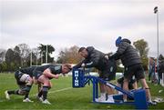 28 November 2022; Tadhg Furlong prepares to scrum with James Ryan, left, Ed Byrne and Head physiotherapist Garreth Farrell, right, during a Leinster Rugby squad training session at Old Belvedere RFC in Dublin. Photo by Harry Murphy/Sportsfile