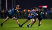 30 November 2022; Ben O'Carroll of UCD in action against Darragh Lyons, left, and Colin Walsh of Maynooth University during the Electric Ireland Higher Education Senior Football Division 1 League Final match between UCD and Maynooth University at the Dublin City University Sports Campus in Dublin. Photo by Seb Daly/Sportsfile