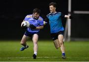 30 November 2022; Jeaic McKelvey of UCD in action against Colm Harnett of Maynooth University during the Electric Ireland Higher Education Senior Football Division 1 League Final match between UCD and Maynooth University at the Dublin City University Sports Campus in Dublin. Photo by Seb Daly/Sportsfile