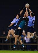 30 November 2022; Darragh Warnock of Maynooth University in action against Malachy Stone, left, and Senan Forker of UCD during the Electric Ireland Higher Education Senior Football Division 1 League Final match between UCD and Maynooth University at the Dublin City University Sports Campus in Dublin. Photo by Tyler Miller/Sportsfile