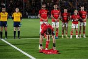 2 December 2022; Munster captain Peter O'Mahoney lays a number 5 jersey in memory of Doddie Weir, who passed away on November 26th, before the United Rugby Championship match between Edinburgh and Munster at the Dam Heath Stadium in Edinburgh, Scotland. Photo by Paul Devlin/Sportsfile