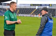 3 December 2022; Ballyea manager Robbie Hogan in conversation with match referee Michael Kennedy before the AIB Munster GAA Hurling Senior Club Championship Final match between Ballygunner of Waterford and Ballyea of Clare at FBD Semple Stadium in Thurles, Tipperary. Photo by Ray McManus/Sportsfile
