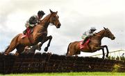 4 December 2022; Teahupoo, left, with Jack Kennedy up, jumps the last during the first circuit on their way to winning the Bar One Racing Hatton's Grace Hurdle, from third place Honeysuckle, right, with Rachael Blackmore up, at Fairyhouse Racecourse in Ratoath, Meath. Photo by Seb Daly/Sportsfile