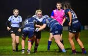 7 December 2022; Shannon Doran of Midlands is tackled by Sarah Moody, left, and Hope Lowney of Metro during the Bank of Ireland Leinster Rugby Sarah Robinson Cup Round 3 match between Metro and Midlands at Coolmine RFC in Dublin. Photo by Seb Daly/Sportsfile