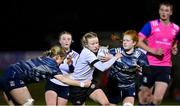 7 December 2022; Aoife Hughes of Midlands is tackled by Mia Gordon, left, and Isobel O’Sullivan of Metro during the Bank of Ireland Leinster Rugby Sarah Robinson Cup Round 3 match between Metro and Midlands at Coolmine RFC in Dublin. Photo by Seb Daly/Sportsfile