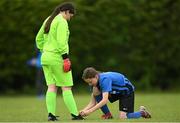 16 May 2022; Stepaside goalkeeper Lilian Tobin has her shoelace tied by teammate Zoe Whelan during the 2022 Clubforce DDSL Girls U13 League Cup Final match between Stepaside FC and Peamount United at the AUL in Dublin. Photo by Harry Murphy/Sportsfile