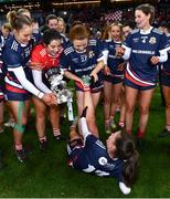 10 December 2022; Lynsey Noone of Kilkerrin-Clonberne is assisted by her teammates after picking up a cramp in the celebrations after the 2022 currentaccount.ie LGFA All-Ireland Senior Club Football Championship Final match between Donaghmoyne of Monaghan, and Kilkerrin-Clonberne of Galway at Croke Park in Dublin. Photo by Ben McShane/Sportsfile