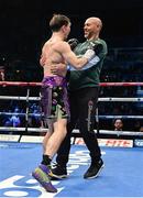 10 December 2022; Michael Conlan, and his trainer Adam Booth, celebrate defeating Karim Guerfi in the first round of their featherweight bout at the SSE Arena in Belfast. Photo by Ramsey Cardy/Sportsfile
