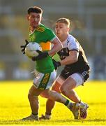 11 December 2022; Tiarnán Flannagan of Glen in action against Jerome Johnston of Kilcoo during the AIB Ulster GAA Football Senior Club Championship Final match between Glen Watty Graham's of Derry and Kilcoo of Down at the Athletics Grounds in Armagh. Photo by Ben McShane/Sportsfile