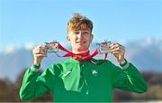 11 December 2022; Nicholas Griggs of Ireland, with his U20 men's team silver medal, and individual silver medal after competing in the U20 men's 6000m during the SPAR European Cross Country Championships at Piemonte-La Mandria Park in Turin, Italy. Photo by Sam Barnes/Sportsfile