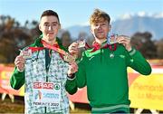 11 December 2022; Dean Casey, left, holds his U20 men's team silver medal, and bronze individual medal, and Nicholas Griggs of Ireland, holds his U20 men's team silver medal, and individual silver medal, after competing in the U20 men's 6000m during the SPAR European Cross Country Championships at Piemonte-La Mandria Park in Turin, Italy. Photo by Sam Barnes/Sportsfile
