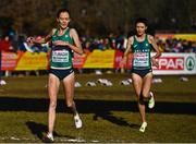 11 December 2022; Ireland's Eilish Flanagan, left, and her twin sister Roisin Flanagan cross the finish line after competing in senior women's 8000m  during the SPAR European Cross Country Championships at Piemonte-La Mandria Park in Turin, Italy. Photo by Sam Barnes/Sportsfile
