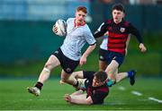 15 December 2022; Calum Murphy of Kildare Town CS evades the tackle of Daniel O'Connell of St Mary's-Edenderry during the Bank of Ireland Leinster Rugby Division 3A SCT Development Shield match between Kildare Town Community College and St. Mary's Secondary School, Edenderry at Energia Park in Dublin. Photo by Ben McShane/Sportsfile