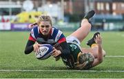 17 December 2022; Anna Doyle of Blackrock College scores her side's fourth try, despite the tackle of Railway Union's Stephanie Carroll, during the Energia AIL Women's Division Final match between Blackrock College and Railway Union at Energia Park in Dublin. Photo by Seb Daly/Sportsfile