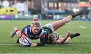 17 December 2022; Anna Doyle of Blackrock College scores her side's fourth try, despite the tackle of Railway Union's Stephanie Carroll, during the Energia AIL Women's Division Final match between Blackrock College and Railway Union at Energia Park in Dublin. Photo by Seb Daly/Sportsfile