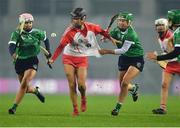 17 December 2022; Catrin Dobbin of Loughgiel Shamrocks in action against Cora Kenny, 12, and Laura Ward of Sarsfields during the AIB All-Ireland Senior Camogie Club Championship Final match between Sarsfields of Galway and Loughgiel Shamrocks of Antrim at Croke Park in Dublin. Photo by Stephen Marken/Sportsfile