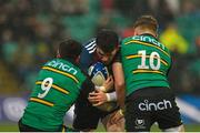 18 December 2022; Calvin Nash of Munster is tackled by Alex Mitchell, left, and Fin Smith of Northampton Saints during the Heineken Champions Cup Pool B Round 2 match between Northampton Saints and Munster at Franklin's Gardens in Northampton, England. Photo by Seb Daly/Sportsfile