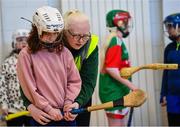 19 December 2022; Sara McFadden of Vision Sports Ireland with participant Edith Toomey from Cabra in Dublin at the inaugural GAA Vision Sports Hurling Event, which was held at at Gaelscoil Chaladh an Treoigh in Newcastle, Limerick, where Limerick hurling stars Declan Hannon and Aaron Costello were in attendance. Photo by Piaras Ó Mídheach/Sportsfile