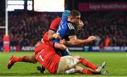 26 December 2022; Scott Penny of Leinster is tackled by Dave Kilcoyne, left, and Tadhg Beirne of Munster during the United Rugby Championship match between Munster and Leinster at Thomond Park in Limerick. Photo by Eóin Noonan/Sportsfile