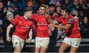 26 December 2022; Patrick Campbell of Munster, left, celebrates with teammates Jack Crowley and Antoine Frisch, right, after scoring his side's third try during the United Rugby Championship match between Munster and Leinster at Thomond Park in Limerick. Photo by Piaras Ó Mídheach/Sportsfile