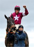 28 December 2022; Jockey Jack Kennedy and groom Camila Sharples celebrate with Conflated after winning the Savills Steeplechase on day three of the Leopardstown Christmas Festival at Leopardstown Racecourse in Dublin. Photo by Seb Daly/Sportsfile