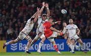 1 January 2023; Jack Crowley of Munster clears under pressure from Greg Jones, left, and Kieran Treadwell of Ulster during the United Rugby Championship between Ulster and Munster at Kingspan Stadium in Belfast. Photo by Ramsey Cardy/Sportsfile
